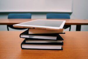 Pile of books topped by a tablet