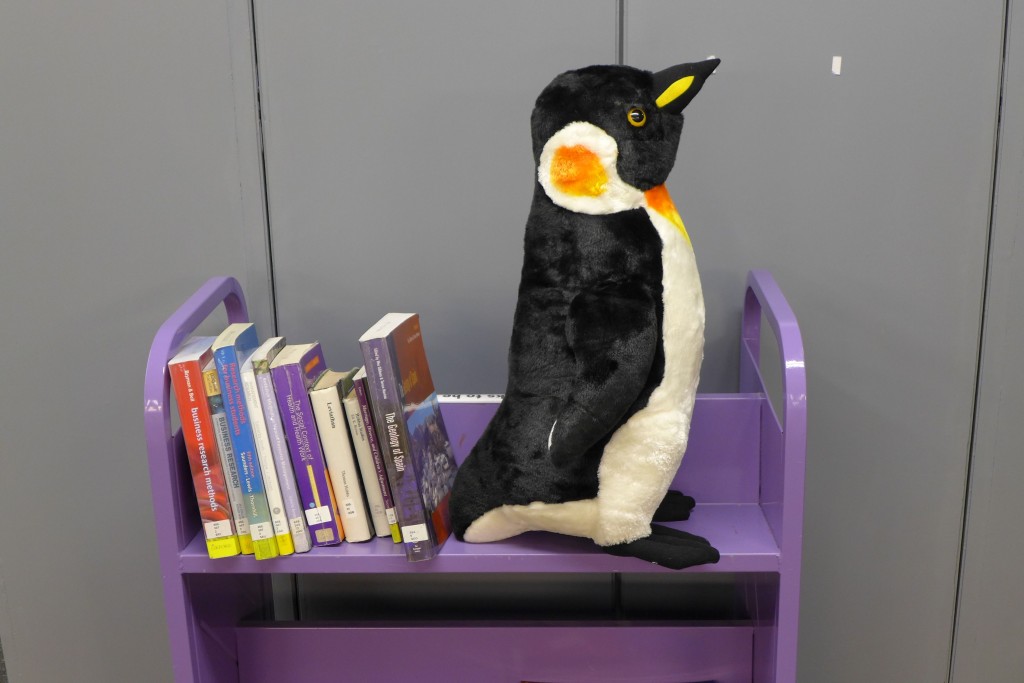 Sitting on a shelving trolley (waiting to be shelved)