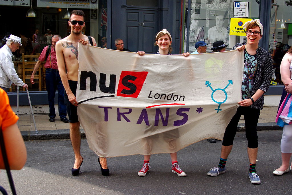 Trans students carrying a banner reading "NUS London Trans*".