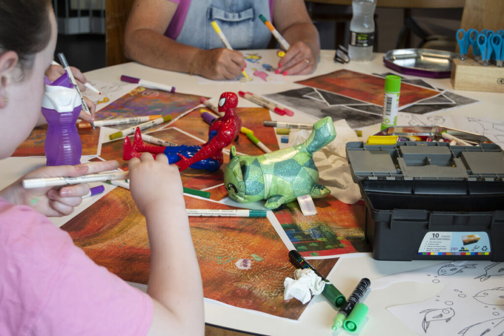 Children creating artworks inspired by books from the Outside In World collection of children's books in translation