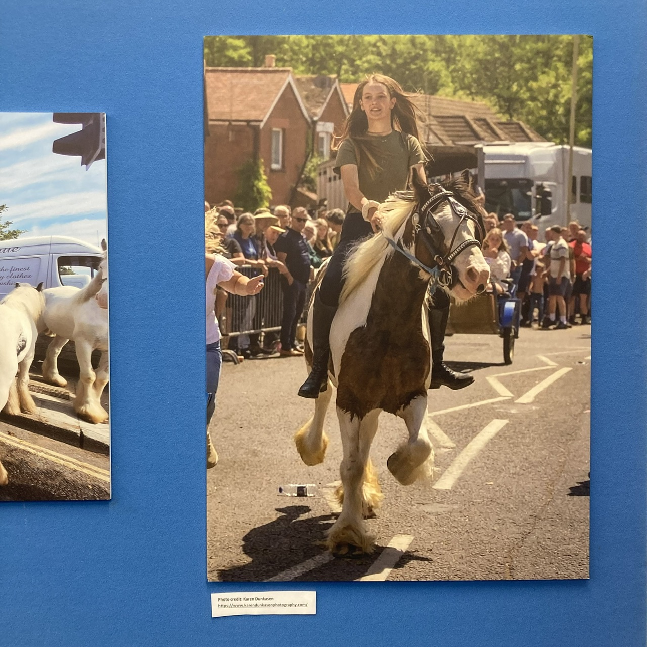 Woman riding a horse along a street